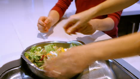 close up of woman is washing lettuce in the kitchen