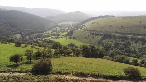 aerial view idyllic vast lush green rural misty mountain valley countryside pull back