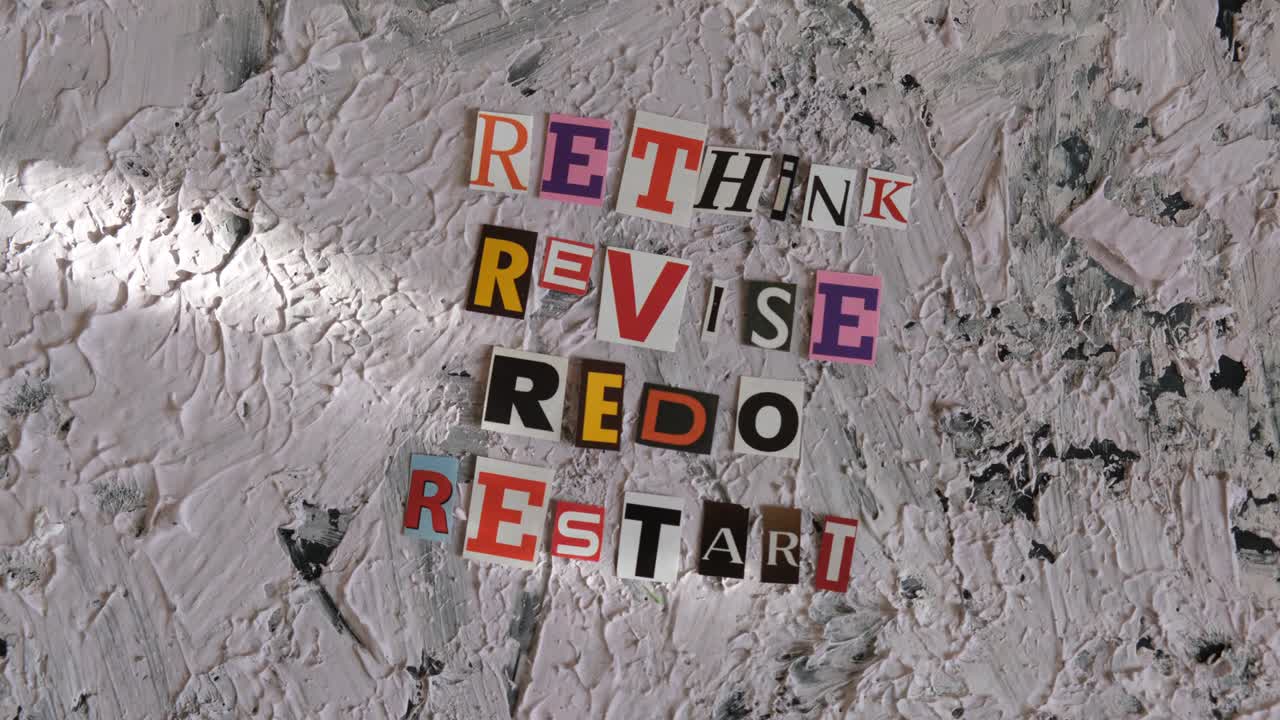 rethink, revise, redo, restart words from cut paper letters. shadow and light, camera movement