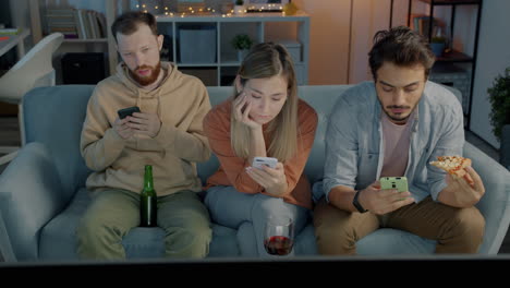 friends watching tv and using phones