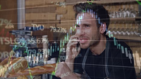 Animation-of-stock-market-data-processing-over-caucasian-male-waiter-talking-on-smartphone-at-cafe