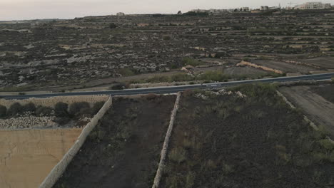 Aerial-Footage-of-a-runner,-male-jogging-at-sunset