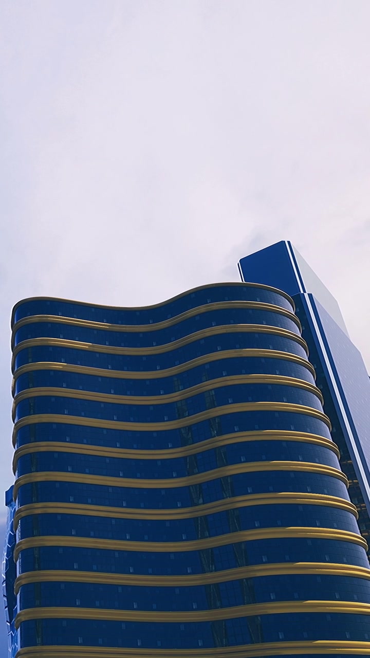 Edifício moderno com linhas curvas e vidro azul no horizonte da cidade.