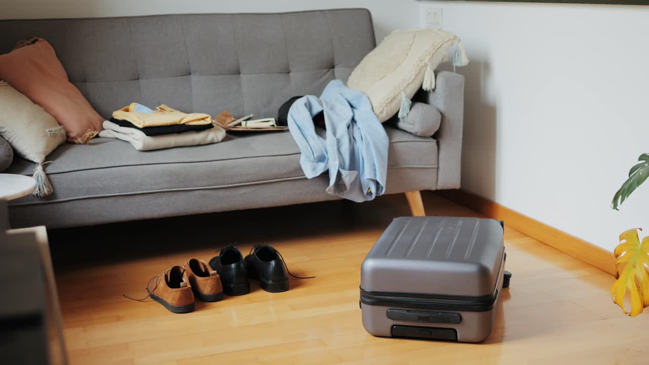 Tourism and travelling concept. Handsome business man going on holiday, packing his suitcase, checking luggage, sitting on bed and looking at packed things