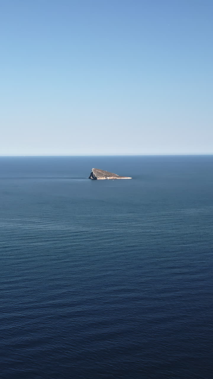 Aerial drone view of the small Benidorm Island and nature reserve on the Mediterranean Sea in Benidorm, Spain. Vertical