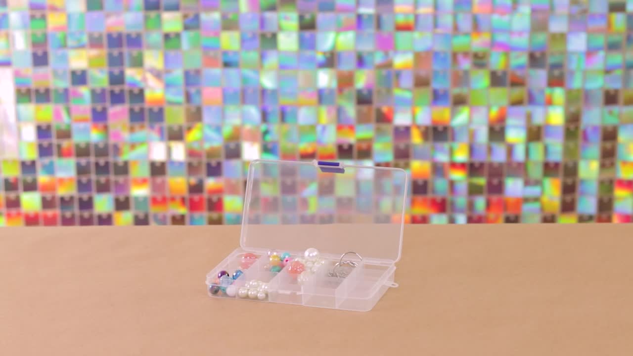 Plastic organizer box with colorful beads for handmade jewelry, establisher