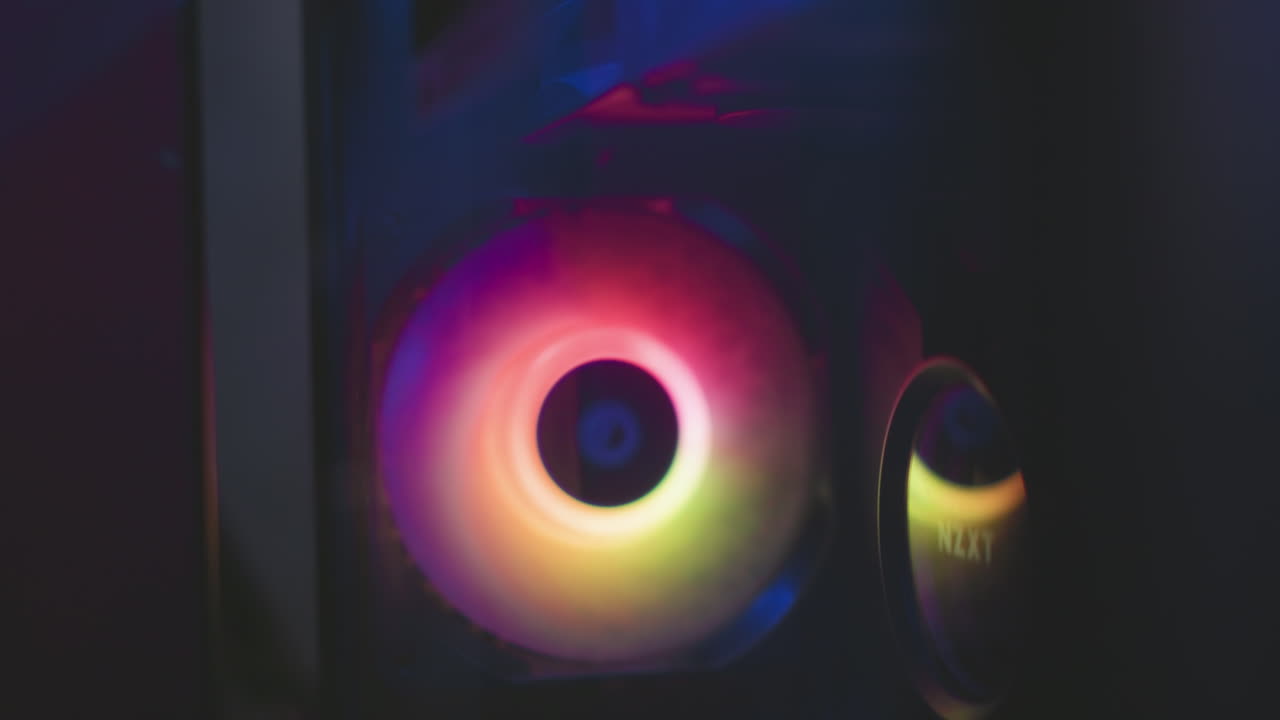 Digital speaker with rotating colorful hues creating dynamic light reflections in dark studio, showcasing vibrant RGB tones in circular pattern emitting futuristic aesthetic and ambient glow effect