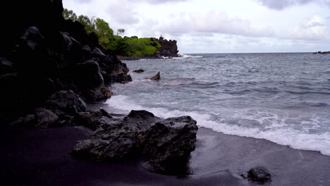 Playa-De-Arena-Negra-En-El-Parque-Estatal-Waianapanapa-A-Lo-Largo-De-La-Carretera-A-Hana-En-East-Maui,-Hawai,-Un-Popular-Destino-Turístico-A-Lo-Largo-De-La-Carretera-A-Hana