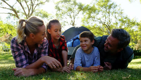 family lying outside the tent on a sunny day
