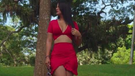 in a tropical caribbean park, a lady in a red dress added a touch of glamour