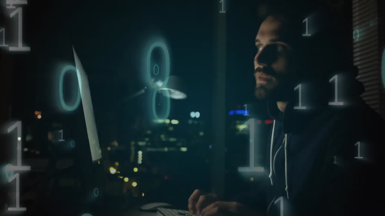Hacker using computer in dark room
