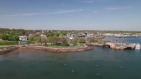long aerial clip of plymouth, massachusetts coastline with mayflower ii and plymouth rock, 4k