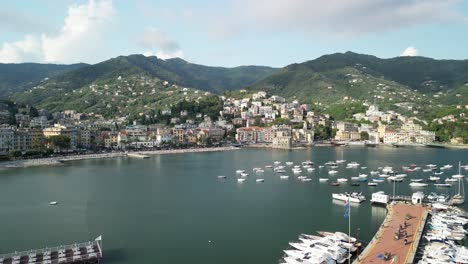 flight over marina and pier towards the city of rapallo nestled on hills