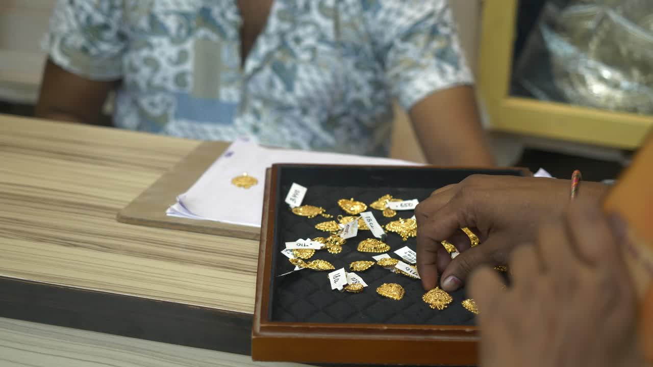 Female customer buying 22k hallmarked gold jewellery at a shop, Gold investment