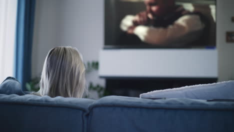 woman watching tv at home