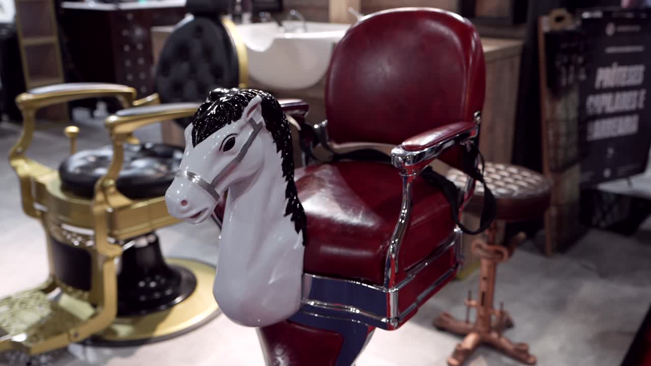 classic red barber chair with toy horse front in vintage setting