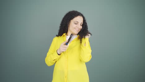 Young-woman-combing-her-hair.