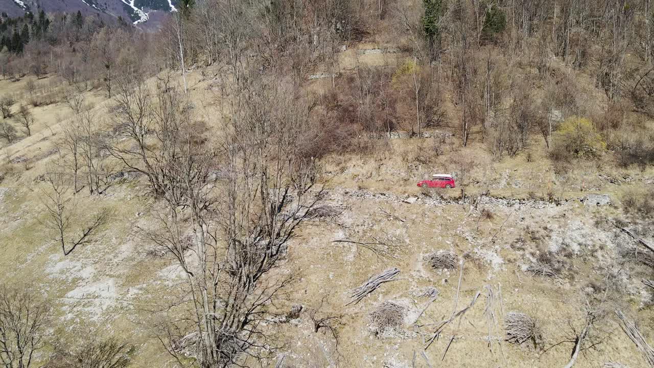 View of car on a narrow road crossing rugged mountain in remote Slovenian nature