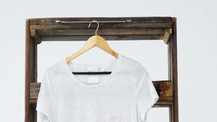 T-shirt appesa a un telaio di legno.