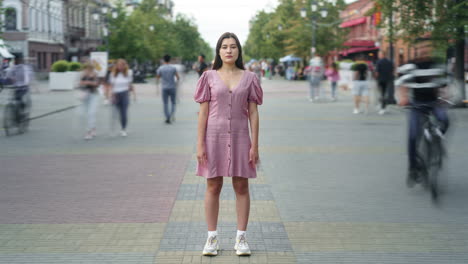 woman in a pink dress on a city street