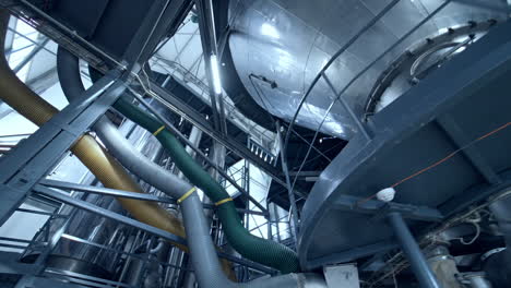 new metal industry inside. dairy production plant with stainless tubes. interior of modern milk factory. view from below.