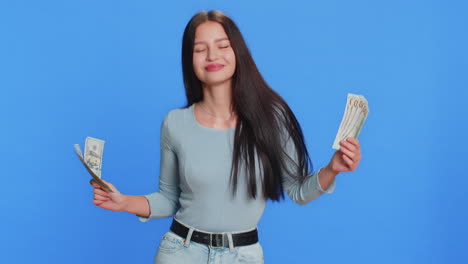 happy woman holding fan of cash money dollar banknotes celebrate success win victory wealth dancing