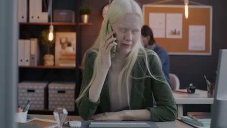 young woman talking on phone in office