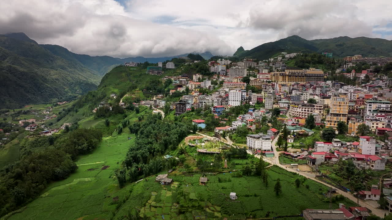 Sapa town with rice terrace fields overlooking mountain passes under the cloudy sky, Panoramic view