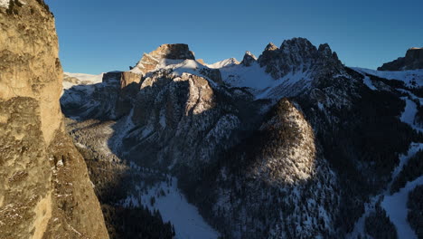 man standing on snow covered mountain, selva di val gardena ski resort, italy