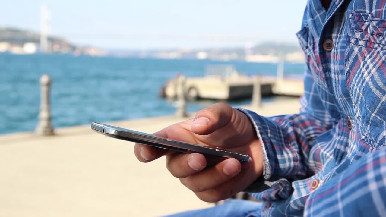 Close Up Shot Of Man'S Hands With Mobile Phone On Background Sea View 1