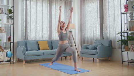 joven atleta asiática haciendo ejercicio, estirándose y practicando yoga en casa. estilo de vida saludable, fitness, bienestar y concepto de atención plena