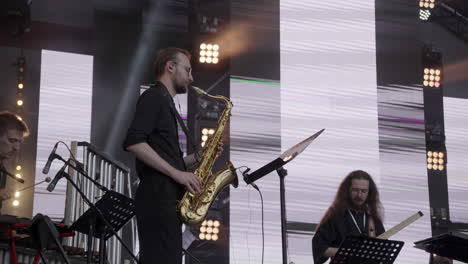 saxophonist performing on stage at a concert