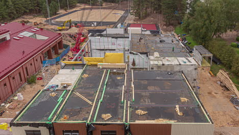 Time-lapse-of-a-large-construction-site-with-cranes,-trucks-and-heavy-equipment