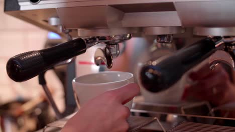 coffee maker pouring coffee at cafe