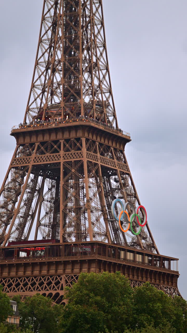 The Eiffel Tower with the Olympic Games sign in Paris, France. Verticalpst