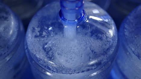 a close-up shot of water bottles being filled with fresh, purified water