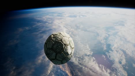 old soccer ball in space on earth orbit