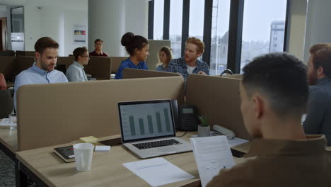 Mixed-race-team-working-in-open-space.-Businesswoman-talking-with-coworker