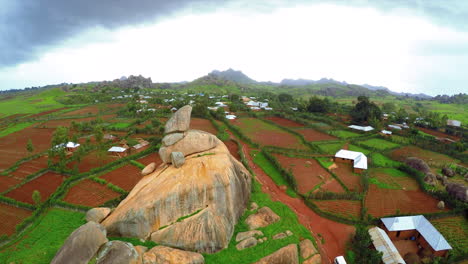 farming community in the plateau state of nigeria with an iconic rock formation - aerial