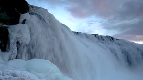 fast flowing water of faxi waterfall with icicles at winter season in iceland