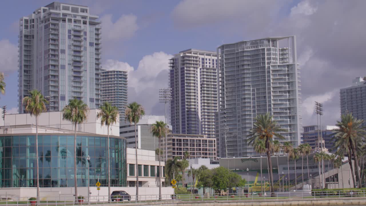 Skyscraper office buildings in downtown St. Petersburg, Florida with a vehicle driving by with stable video wide shot