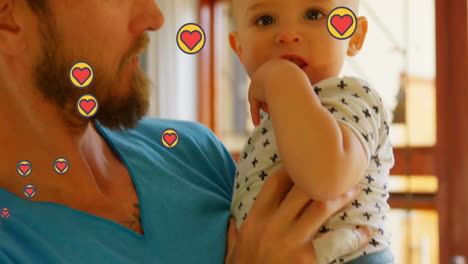 animation of heart icons over caucasian father with baby