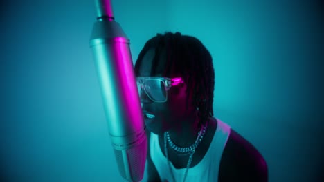 man singing into microphone in studio