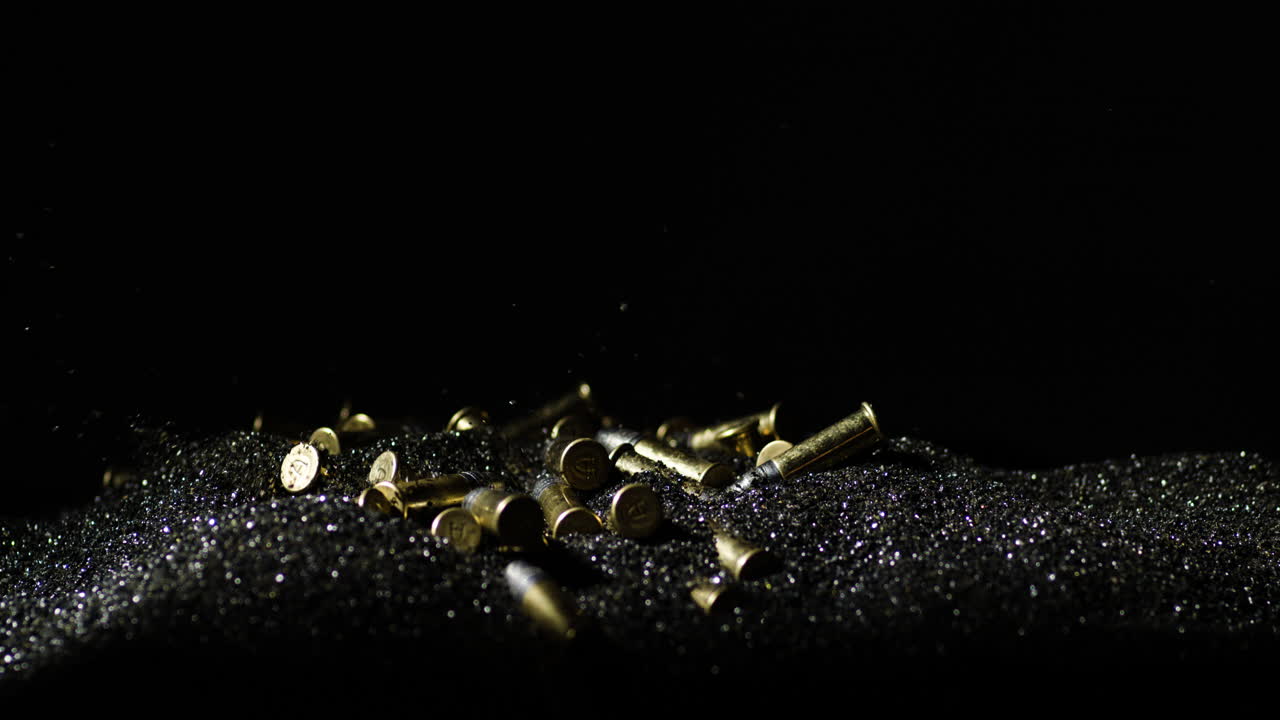 Closeup Of 22 Long Rifle Ammunition Bullets Falling On Bullet Grains In Slow Motion