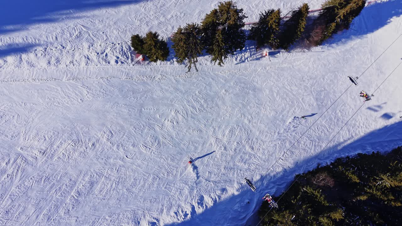 People ski on snowy slopes in the Carpathians in Bulgaria during winter