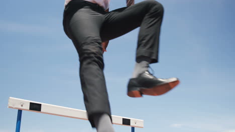 businessman doing hurdle race