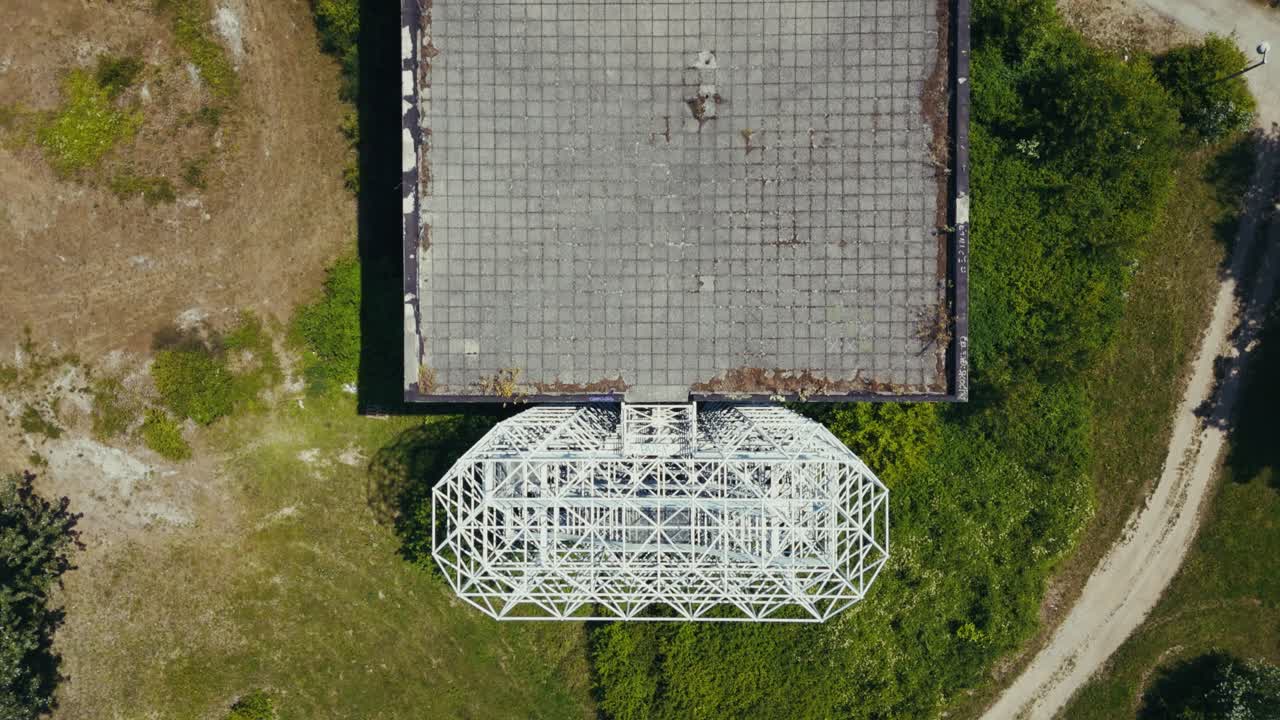 aerial - geometric steel frame on rooftop of abandoned building in Zagreb Croatia in summer