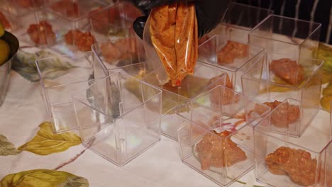 chef preparing smoked paper bill purée food starters placed on outdoor catering table