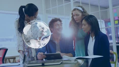 animation of globe over diverse people working together with tablet