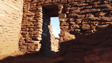 forward diagonal dolly zoom inside old ruins of wukoki pueblo